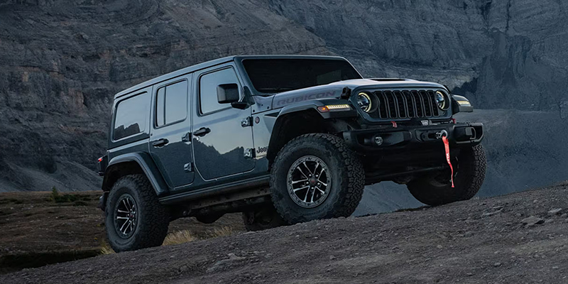 A Jeep Wrangler Rubicon four-door driving off-road